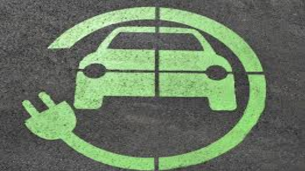 A symbol for an electric car with a green electrical cord and plug circling a green car.