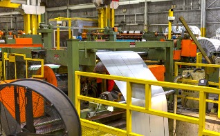 National Material Company’s steel slitting line, East Chicago, Plant 2. Slit steel exits into “the looping pit,” which will release any tension before recoiling.