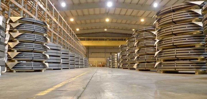 NMC’s huge warehouse has its steel supply neatly organized on the sides.