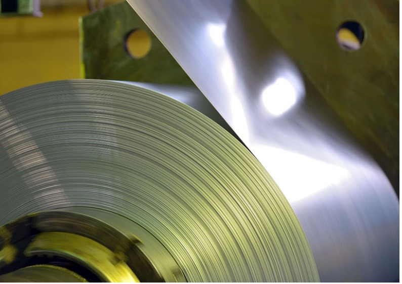 A close-up image of a steel coil in an industrial setting.